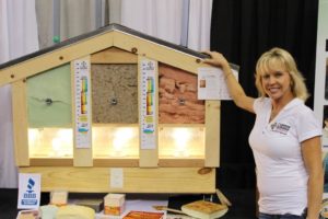 Owner Monica Boshnack showing the difference between fiberglass, cellulose, and spray foam insulation.