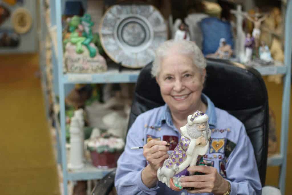 Mary Cortez painting at Wagon Wheel, her ceramic shop.