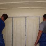 Contractors cleaning up spray foam insulation