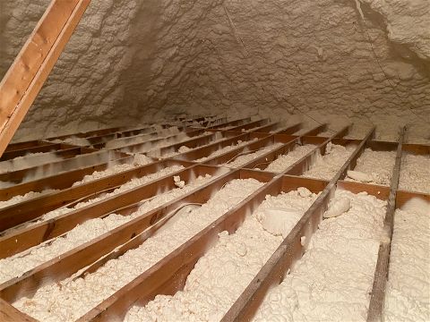 Attic floor with open cell spray foam insulation