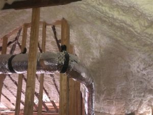 Attic with tubing and open cell spray foam