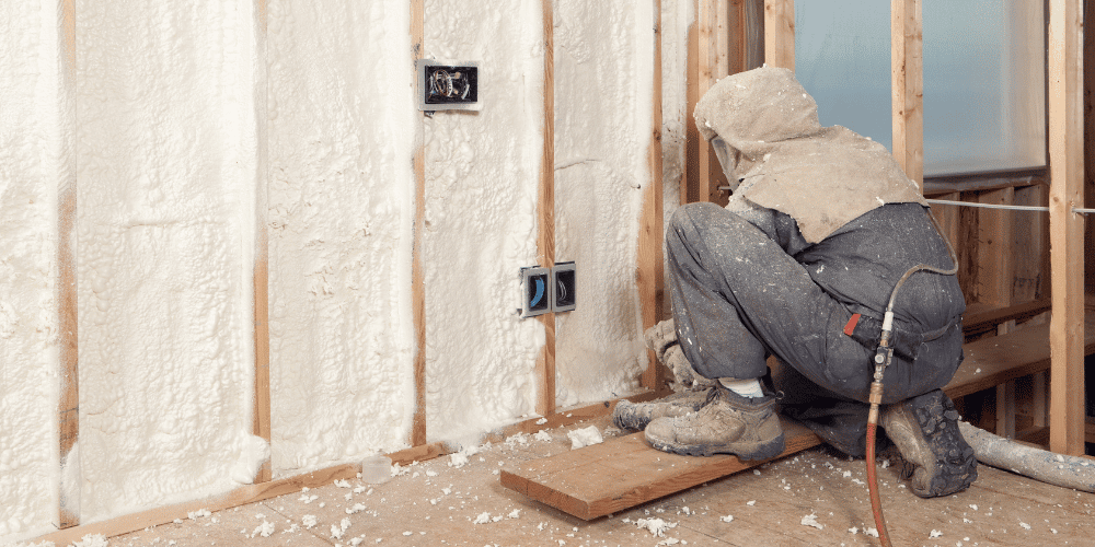 Professional contractor installing spray foam insulation