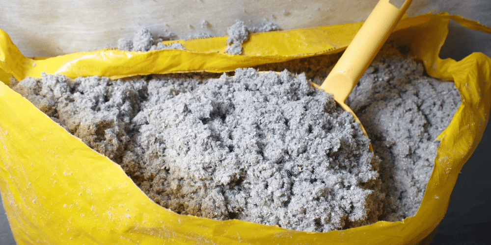 A bag of cellulose insulation being prepared for application