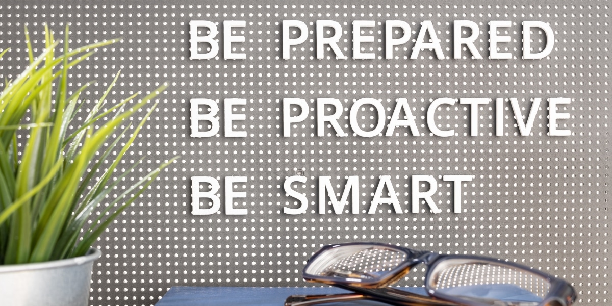A board with the text "be prepared, be proactive, be smart" written on it