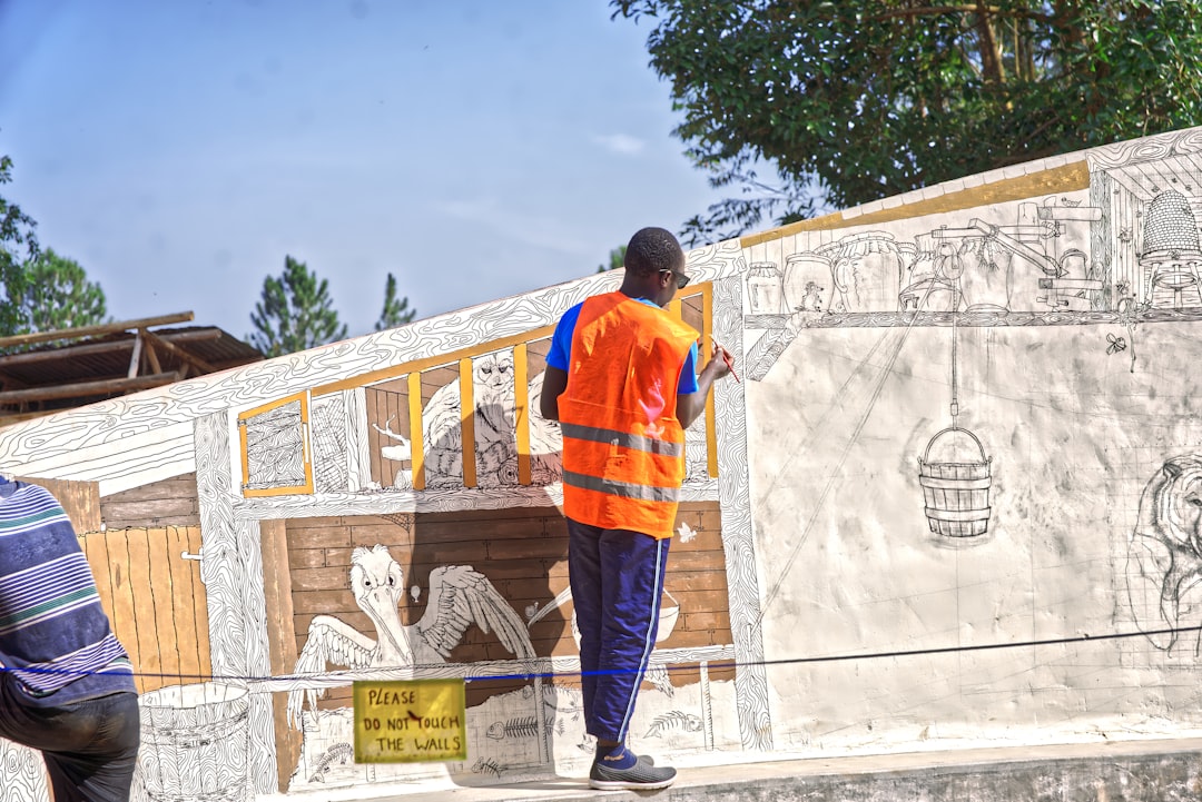 A construction worker in full protective gear expertly applying closed-cell spray foam, showcasing the high-tech solution to foundation instability.