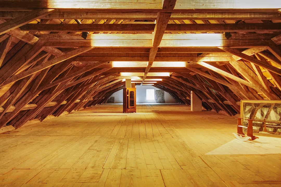 A detailed close-up of old, compressed, and dirty fiberglass insulation in an attic, showing its poor condition and highlighting the need for an upgrade to improve energy efficiency.
