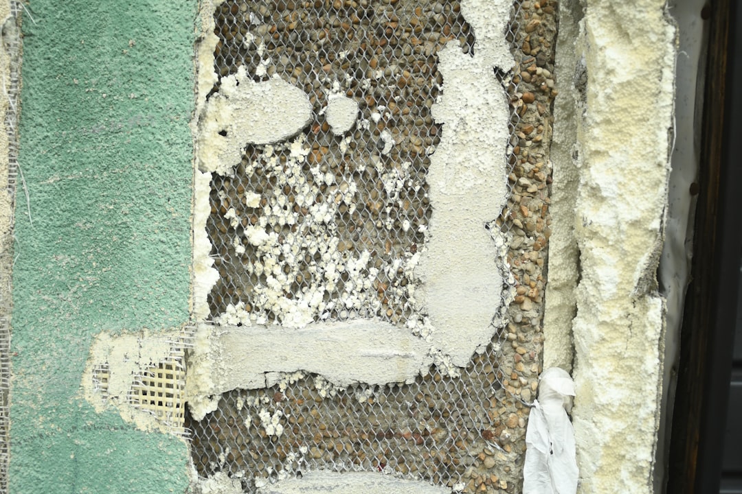 A detailed close-up of defective spray foam insulation, showing cracks and an unhealthy yellow color which signifies an incorrect, off-ratio chemical mixture.