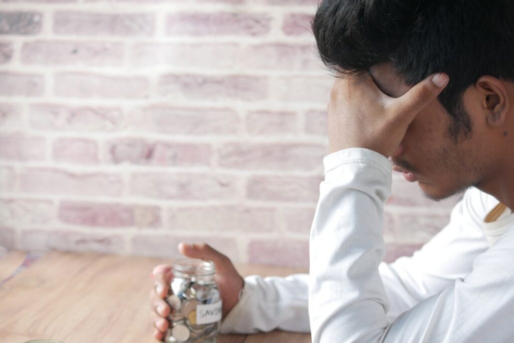 Frustrated homeowner looks at a shockingly high electricity bill in their home, representing the financial stress of high ...
