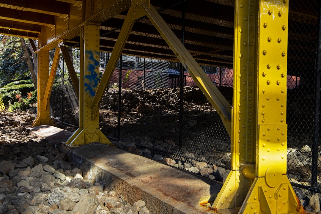 The clean and well-lit crawlspace under a raised pier and beam foundation, showcasing a stable and secure home structure after repairs.