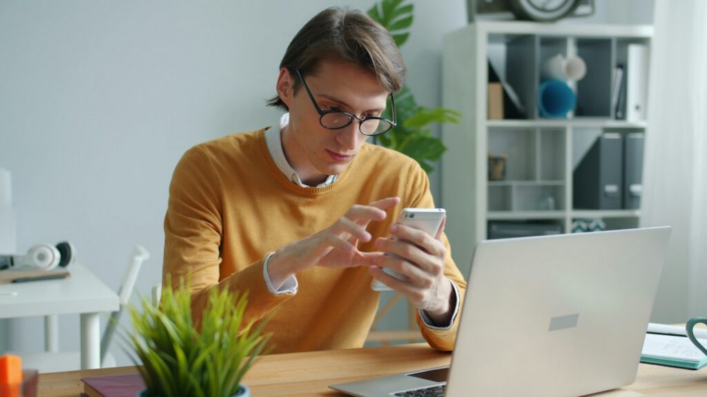 Concerned homeowner sits at their kitchen table, holding an official-looking letter from an insurance company, conveying s...