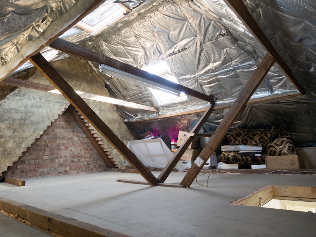 A detailed, professional shot of a contractor applying spray foam insulation into a wall cavity, highlighting the texture and precision of the installation process.